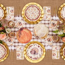 Load image into Gallery viewer, A Thanksgiving table set with floral plates, gold chargers, autumn-themed napkins, gold cutlery, pumpkins, and flower arrangements on a brown checked tablecloth. Sophistiplate’s Amber Harvest Guest Towels (20pk) add a thoughtful touch to each place setting, perfectly complementing the seasonal décor.