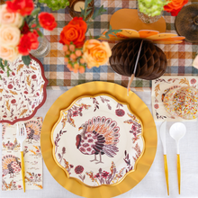 Load image into Gallery viewer, Create a festive Thanksgiving tablescape with the Amber Harvest Table Setting by Sophistiplate, featuring turkey-themed designer disposable plates, gold chargers, floral napkins, gold utensils, and autumn blooms atop a plaid tablecloth. The elegant Amber Harvest collection adds sophistication to your celebration, with a charming honeycomb turkey decoration completing the look.