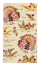 Load image into Gallery viewer, Transform your Thanksgiving table with the Amber Harvest Guest Towels by Sophistiplate, featuring illustrated turkeys with colorful plumage standing among yellow, red, and brown wildflowers on a light background—a festive autumn-themed pattern perfect for holiday napkins.