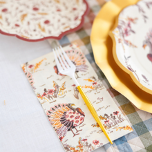 Load image into Gallery viewer, The Amber Harvest Table Setting by Sophistiplate creates a festive autumn tablescape with turkey-themed napkins, a yellow-handled fork, and vibrant harvest party plates, all beautifully arranged on a cheerful plaid tablecloth.
