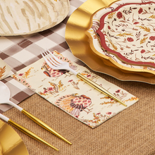 Load image into Gallery viewer, Thank you for your request. Here is the alt text, under 250 characters: Elegant fall table setting with Sophistiplate Amber Harvest Guest Towels featuring turkeys and autumn foliage, gold-edged plates, and gold-handled utensils on a checkered burlap tablecloth.
