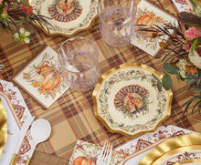 Load image into Gallery viewer, The Turkey &amp; Gourds Table Setting Bundle by Sophistiplate LLC showcases Thanksgiving style with designer disposable plates adorned with turkey motifs, pumpkin-themed napkins, clear glasses, gold-trimmed utensils, and autumn floral centerpieces atop a plaid tablecloth.
